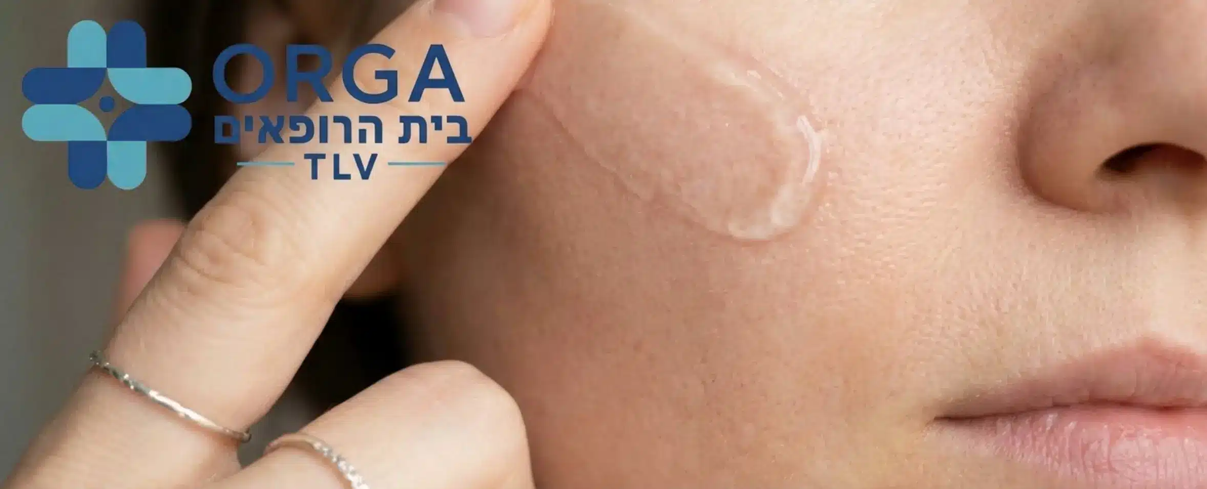 תמונה המציגה מריחה עדינה של ג'ל סיליקון שקוף על אזור הלחי באמצעות אצבע כאשר הג'ל משתלב בטבעיות עם עור הפנים ואינו בולט לעין